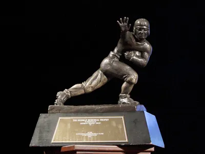 Four quarterbacks are the frontrunners for the most prestigious award in college football. Photo: Britannica.